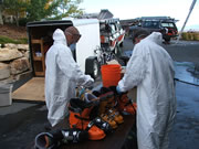 Allstate Animal Control technicians in hazmat suits performing skunk odor treatment